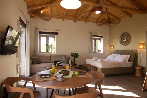 a living room with a bed and a table at Lithorama Residence Mani Complex in Koúmani