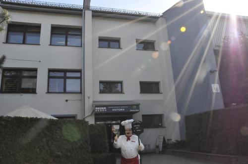 a man is standing in front of a building at Ośrodek Sportu i Rekreacji Victoria in Bielsko-Biała