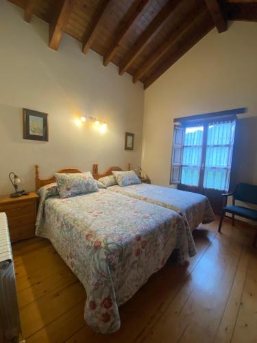 a bedroom with a bed and a window in it at Casa Rural La Xana in Piloña