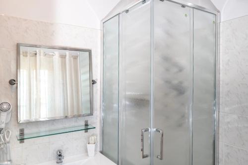 a shower with a glass door in a bathroom at Il risveglio del Poggio in Castiglione dʼOrcia