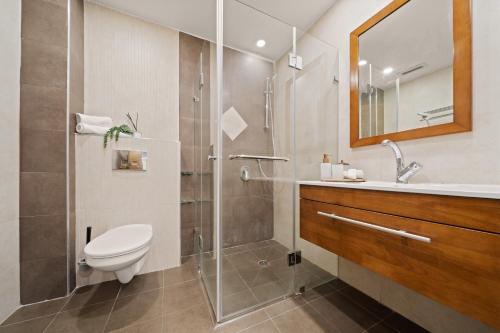 a bathroom with a shower and a toilet and a sink at King David Apartment - J&J in Jerusalem