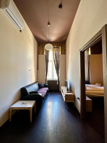 a living room with a couch and a table at Agape Villa Apartments in Novi Sad