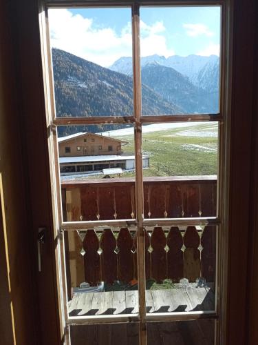 an open window with a view of a mountain view at Obenfigerhof in Kals am Großglockner