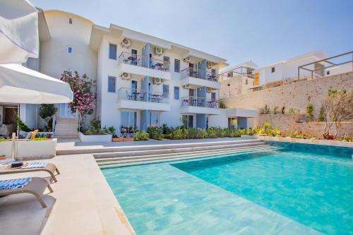 a villa with a swimming pool in front of a building at Mavilim Hotel in Kas