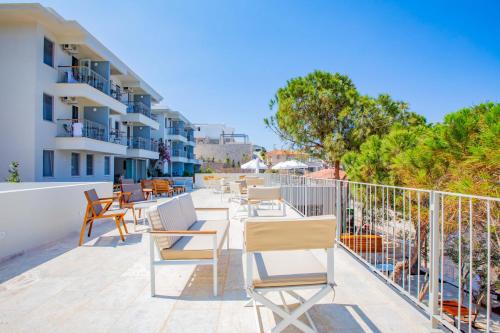 a row of chairs and tables on the balcony of a building at Mavilim Hotel in Kas