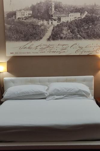 a black and white picture of a bed with pillows at Locanda degli Ulivi in Arcugnano