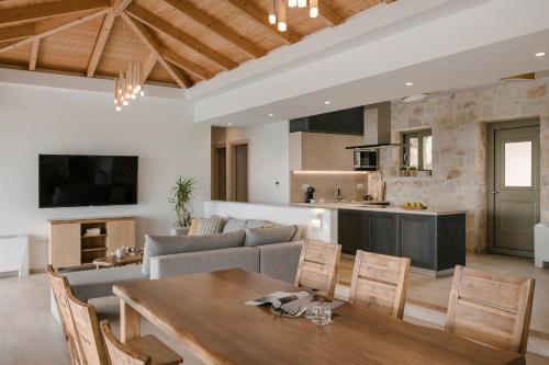 a kitchen and living room with a table and chairs at Villa Templin in Chaliotata