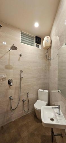 a bathroom with a toilet and a sink at Chippy Inn in Chennai
