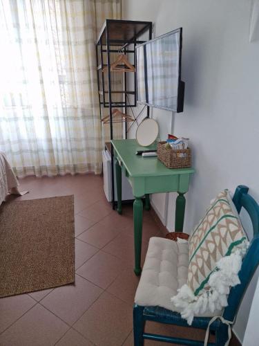 a room with a table and a chair and a desk at Guest house Le Sibille in Taormina