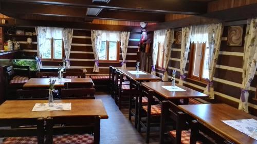 a row of tables and chairs in a restaurant at Pension Alex in Benecko