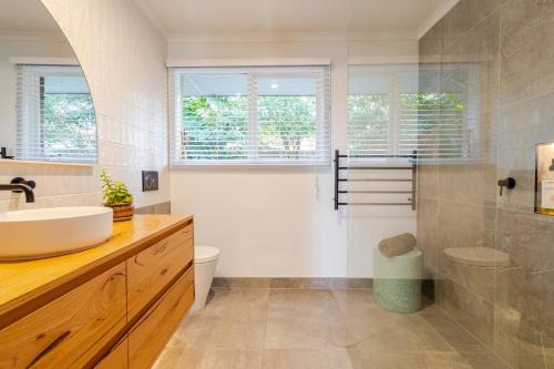 a bathroom with a sink and a toilet and a shower at Frankston South Beachside Gem in Frankston South