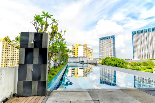 a swimming pool in the middle of a city with tall buildings at The Landmark Penang in Tanjong Tokong