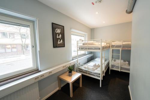 a room with two bunk beds and a window at Stockholm Hostel in Stockholm