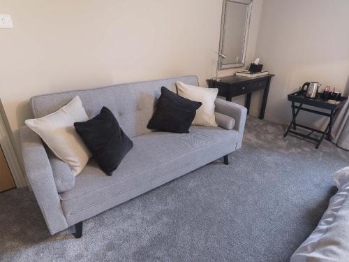 a living room with a couch with pillows on it at New Crown Inn in Appleby
