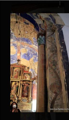 a room with a ceiling with paintings on it at Casa Alba in Chan de Vilar