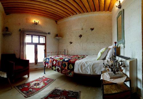 una camera con un letto in una stanza con una finestra di Pigeon Hotel Cappadocia a Üçhisar