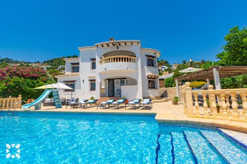 a villa with a swimming pool and a house at Villa Perla by Abahana Villas in Teulada