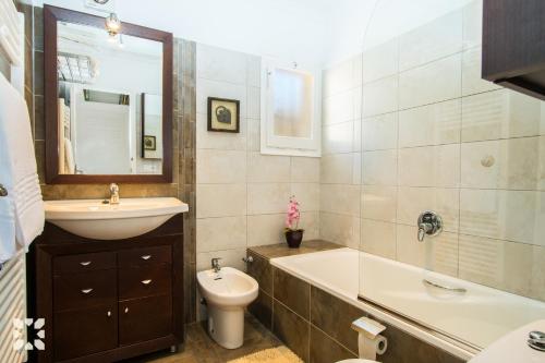 a bathroom with a sink and a tub and a toilet at Villa Paradise by Abahana Villas in Calpe