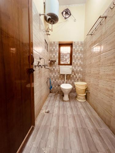 a bathroom with a toilet and a sink at Stayble Homestay in Dehradun