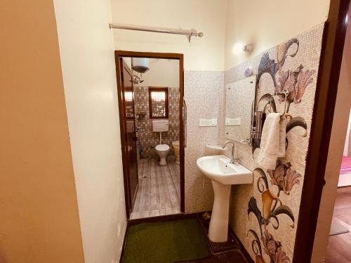 a bathroom with a sink and a toilet at Stayble Homestay in Dehradun