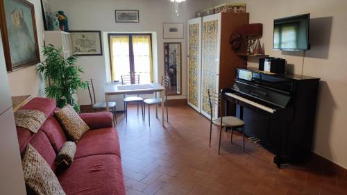 uma sala de estar com um sofá e um piano em Perla sul porticciolo em La Maddalena