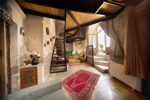 a large room with a staircase in a building at Pigeon Hotel Cappadocia in Uchisar