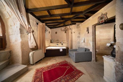 a bathroom with a sink and a chair and a tub at Pigeon Hotel Cappadocia in Uchisar