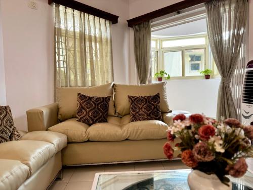 a living room with a couch and a table at La- Maria's By The Beach Goa in Benaulim