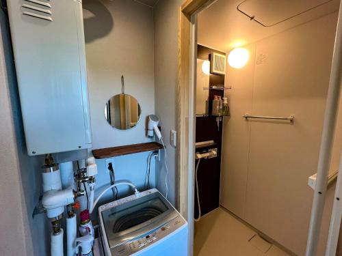 a small kitchen with a washing machine in it at FLEXWORK tawa - Vacation STAY 75820v in Teshikaga