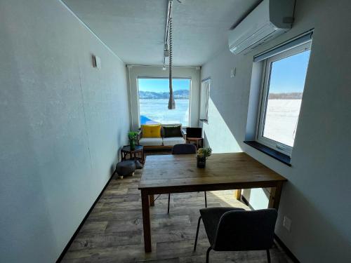 a living room with a table and a view of the ocean at FLEXWORK tawa - Vacation STAY 75820v in Teshikaga