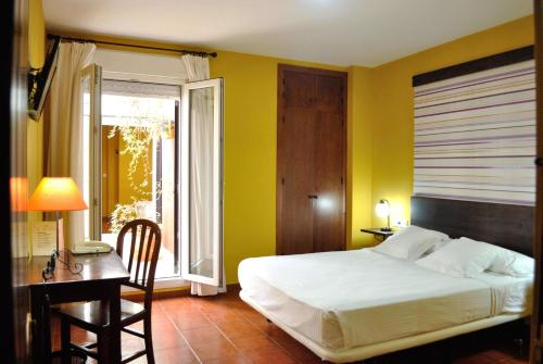 Hostal La Andaluza tesisinde bir odada yatak veya yataklar