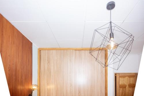 a chandelier hanging from a ceiling next to a door at Maison Meublée *WIFI* *CLIM* *PARKING* in Douala