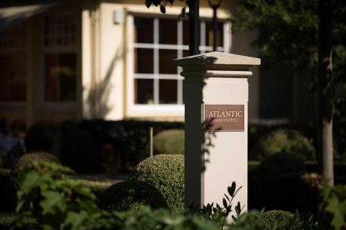 a sign on a pole in front of a house at Atlantic Parkhotel in Baden-Baden