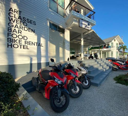 two motorcycles parked in front of a building at Centerpoint Hotel & Plaza in Thongsala