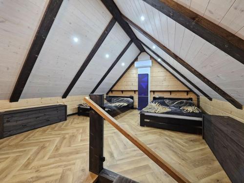 a attic room with two beds in it at Domek nad jeziorem in Krasnopol