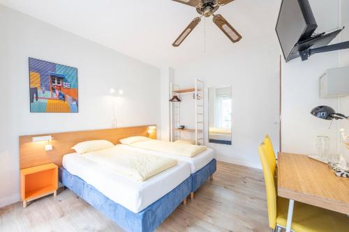 a bedroom with a bed and a dining table at Hotel Atlantico self check-in in Lugano