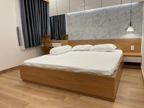 a bedroom with a large bed with white sheets at Căn Hộ Chung cư Hưng Phú in Can Tho