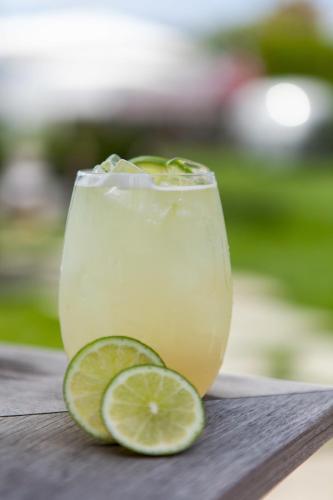 a drink in a glass next to a slice of lime at The Montauk Beach House in Montauk