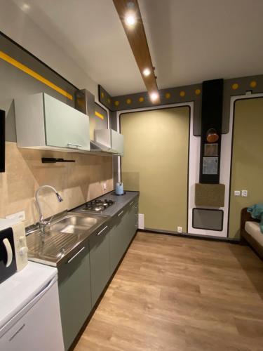 a kitchen with a sink and a door to a room at +Authentic+ in Mariánské Lázně