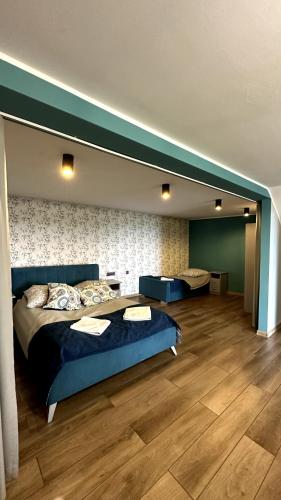 a bedroom with a large bed and a wooden floor at Domki Na Złotym Groniu in Istebna