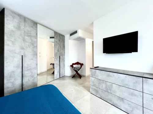 a bedroom with a bed and a tv on a wall at Sole Matto Rooms in Olbia