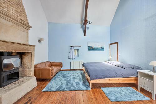 a bedroom with a bed and a fireplace at Augustine Beach - Maison à 700 m de la plage in Courseulles-sur-Mer