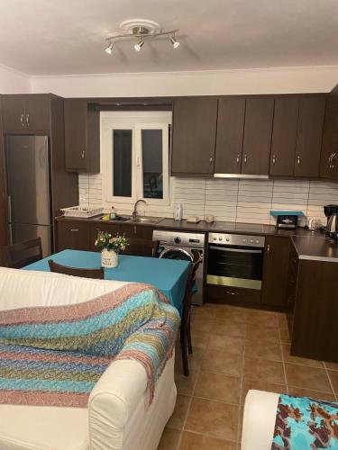 a kitchen with a couch and a table in it at Aphrodite studio in Póndi