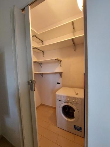 a small laundry room with a washer and dryer at San Fedele Intelvi - Starsirius Apartments in San Fedele Intelvi