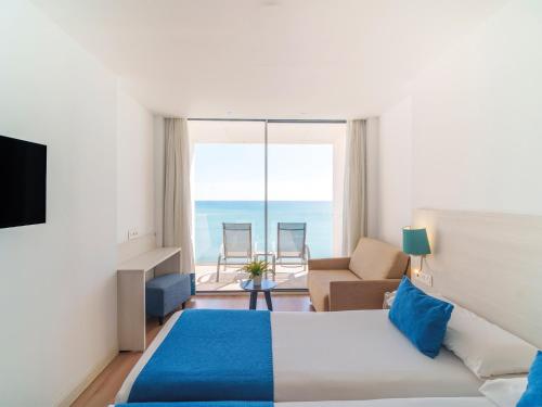 a hotel room with a bed and a view of the ocean at Hotel Benalmadena Beach in Benalmádena