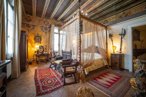 a bedroom with a bed with a canopy at Relais Castello Bevilacqua in Bevilacqua