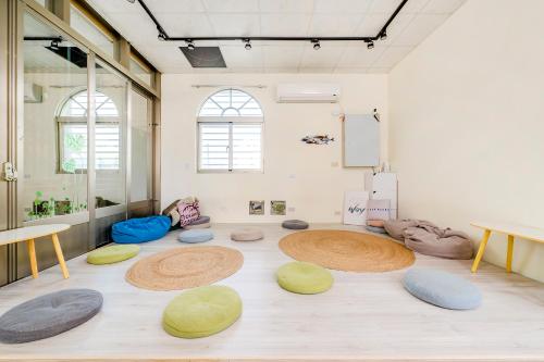 a room with circular objects on the floor at Ocean Diary Hostel in Green Island