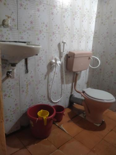 a bathroom with a toilet and a sink at Silver sea in Gokarna