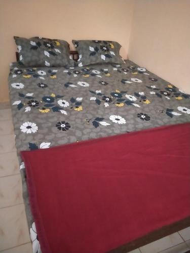 a bed with a blanket with flowers on it at Silver sea in Gokarna