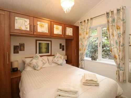 a bedroom with a bed with towels on it at Shoreside Lodge in Bowness-on-Windermere